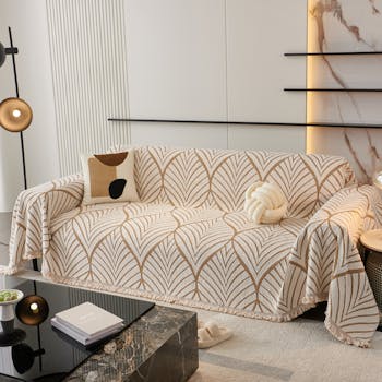A modern living room featuring a beautifully covered sofa with elegant patterns. Ideal for home decor inspiration.